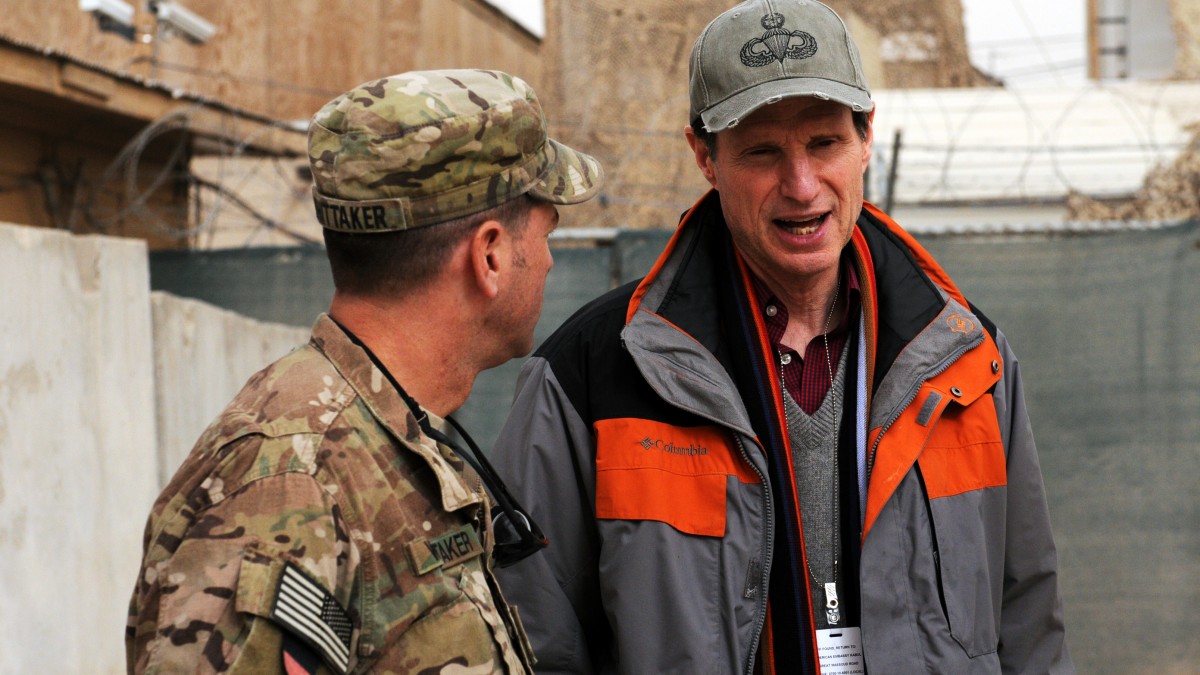 Senator Ron Wyden (D-OR) speaks with 1st Sgt. Douglas W. Whittaker, distribution company first sergeant from Medford, Ore., 25th Brigade Support Battalion, 1st Stryker Brigade Combat team, 25th Infantry Division after a briefing at the RC(S) Headquarters on Kandahar Airfield Jan. 15. Wyden, as part of a congressional delegation, visited the region to receive a context brief regarding political, economic, military and security issues affecting relationships with coalition forces, as well as presenting awards to 25th BSB Soldiers, and touring their motor pool to learn more about the medical evacuation and vehicle recovery vehicles the Soldiers operate. (Photo/U.S. Army Sgt. Amanda M. Hils)