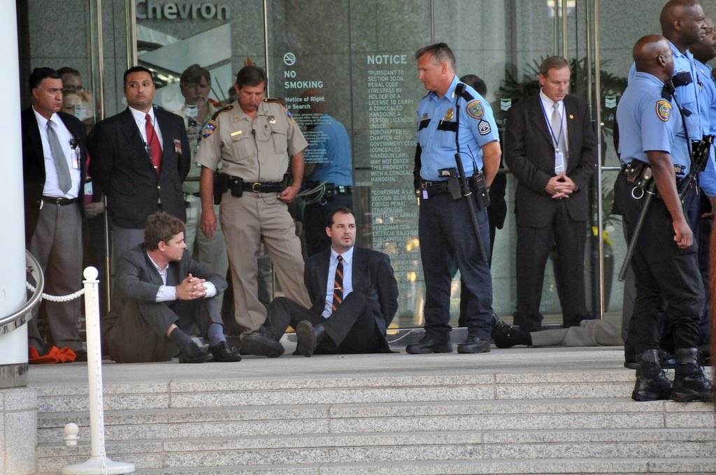 Amazon Watch's Mitch Anderson (L) and Han Shan (R) under arrest outside Chevron's Houston headquarters, before being taken to Houston City Jail Photo by Liana Lopez/Amazon Watch)