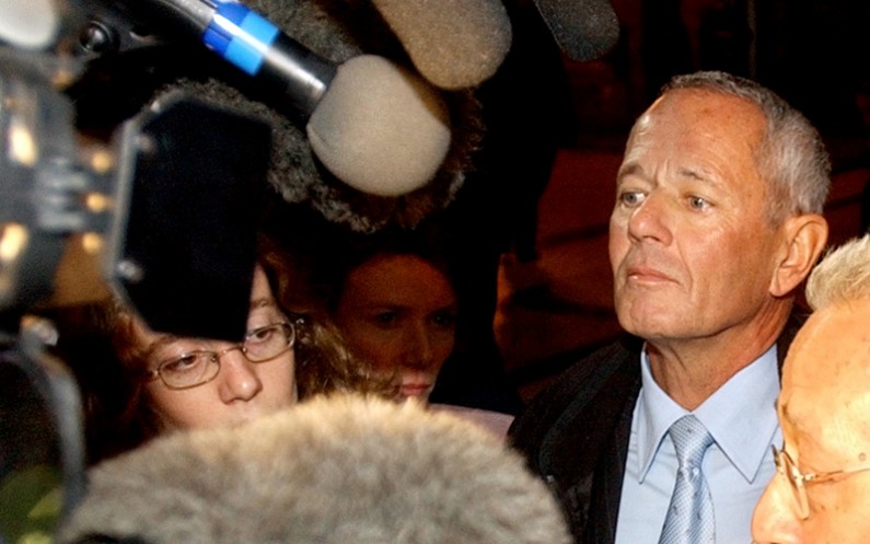 Former Gendarmerie Captain Paul Barril, top right, and his lawyer Jacques Verges face reporters as they arrive at the Paris courthouse Monday, Nov. 15, 2004, at the start of the so-called Elysees wiretaps trial. (AP Photo/Remy de la Mauviniere)