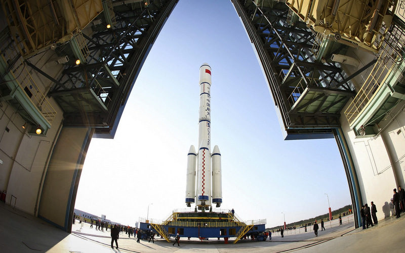 People look at the Long March II-F rocket carrying the China's first space station module Tiangong-1 into orbit at the Jiuquan Satellite Launch Center in northwest China's Gansu province. The Tiangong-1 space station module is built to serve as a rendezvous and docking platform for China's space program. (AP Photo)