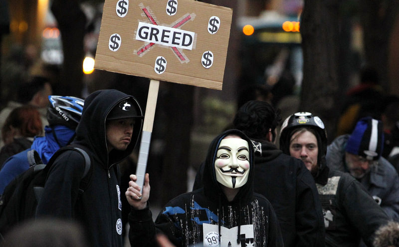 An Occupy protester wears a Guy Fawkes mask while protesting.