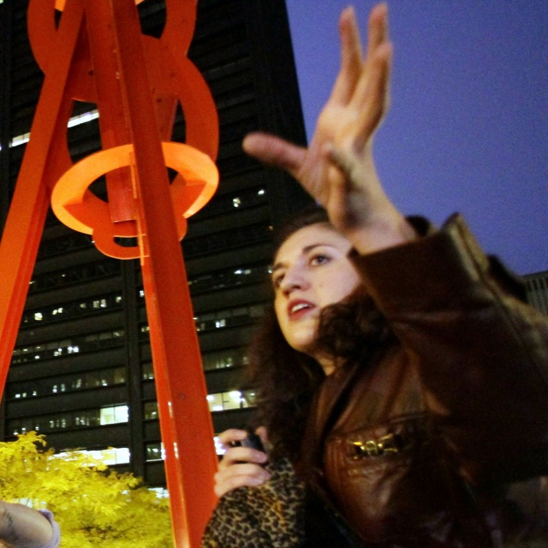 Occupy Wall Street protesters Eric Linkser, left and Cecily McMillan, right, take turns shouting information to protesters preparing to return to Zuccotti Park on Tuesday, Nov. 15, 2011. (AP Photo/Bebeto Matthews)