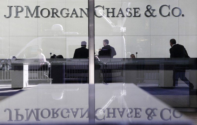 People stand in the lobby of JPMorgan Chase headquarters in New York. J.P. Morgan Chase (AP Photo/Mark Lennihan, File)