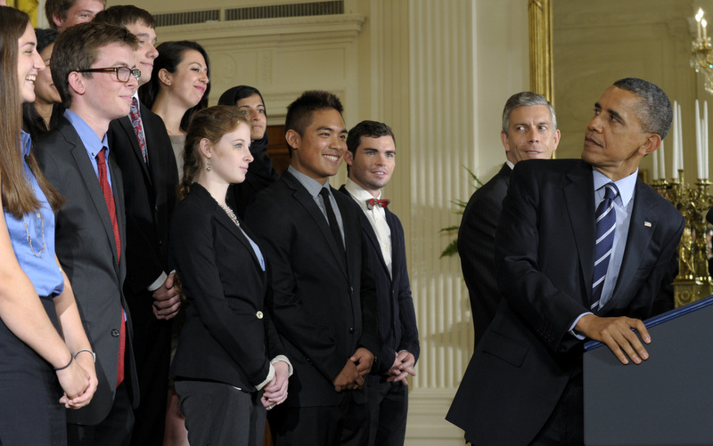 President Barack Obama, right, with Education Secretary Arne Duncan at his side, second from right, looks back at students as he calls on Congress to stop interest rates on student loans from doubling. (AP Photo/Susan Walsh)