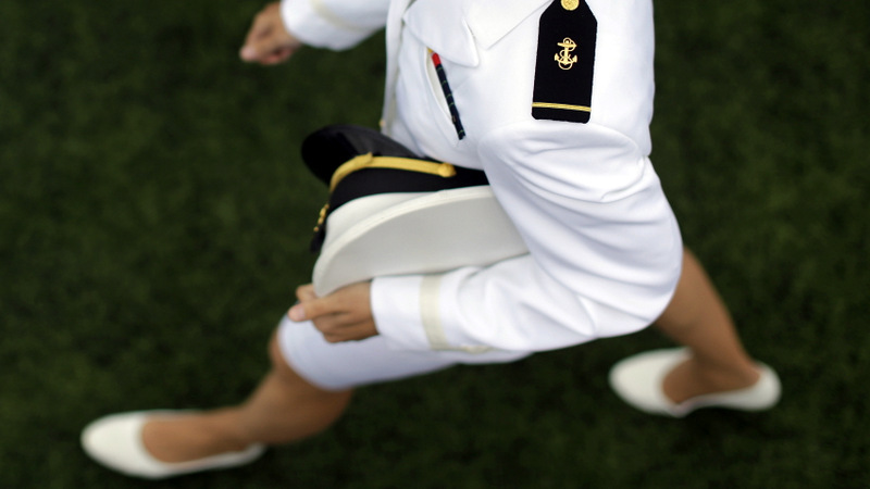  A graduating U.S. Naval Academy Midshipman marches into the Academy's graduation and commissioning ceremonies, Friday, May 24, 2013, in Annapolis, Md. President Barack Obama urged new graduates to exhibit honor and courage in tackling incidents of sexual assault as they assume leadership positions in the military. (AP Photo/Patrick Semansky)