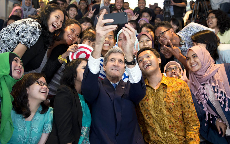 Secretary of State John Kerry takes a selfie with a group of students before delivering a speech on climate change on Sunday, Feb. 16, 2014, in Jakarta. Kerry called for a "global solution" for climate change in the first of several speeches he will deliver this year on the topic. (AP Photo/ Evan Vucci)
