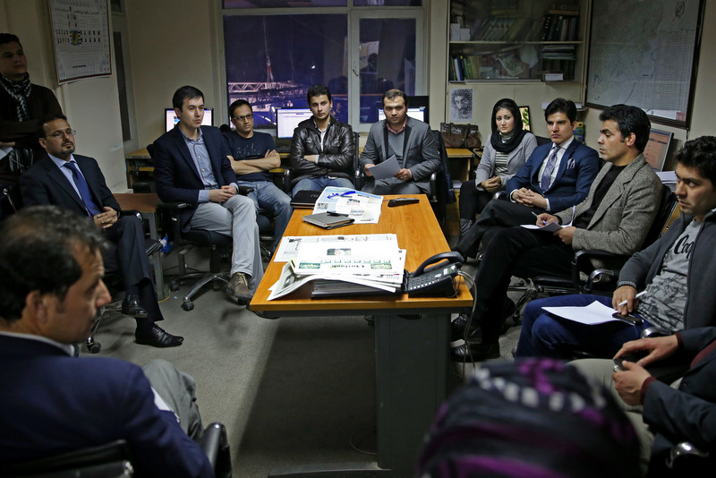 In this Monday, Feb. 3, 2014 photo, Tolo TV staffers talk during a meeting at their office in Kabul, Afghanistan. The proliferation of Afghan media in the past 12 years is one of the most visible bright spots of the fraught project to foster a stable democracy. (AP Photo/Massoud Hossaini)