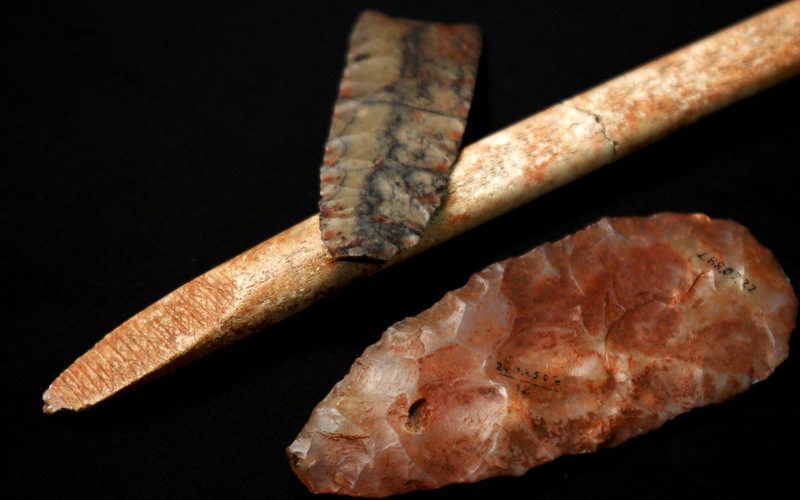 This undated photo provided by researcher Sarah L. Anzick shows a nearly-complete projectile point, top, a mid-stage point made of translucent quartz and an end-beveled rod of bone from a Clovis-era burial site found in 1968 in western Montana. Scientists have recovered and analyzed the DNA of an infant who died more than 12,000 years ago and was buried at the site where these artifacts were found. By comparing the boy’s genome to those of present-day people, the research showed that many of today’s Native Americans are direct descendants of the population the boy belonged to, and that he is closely related to all indigenous American populations, especially in Central and South America, the researchers said. The DNA analysis was reported online Wednesday, Feb. 12, 2014 in the journal Nature. (AP Photo/Sarah L. Anzick)