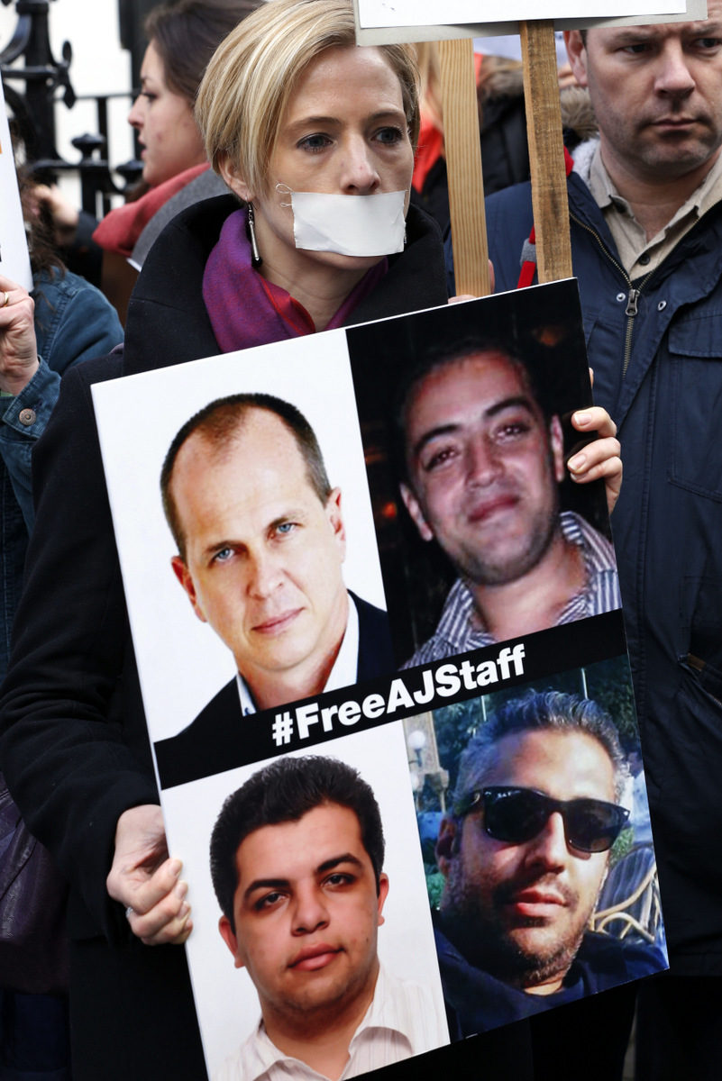Journalists hold placards as they demonstrate