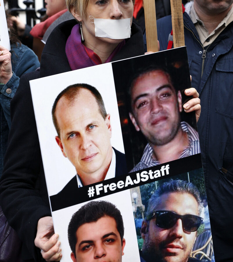 Journalists hold placards as they demonstrate