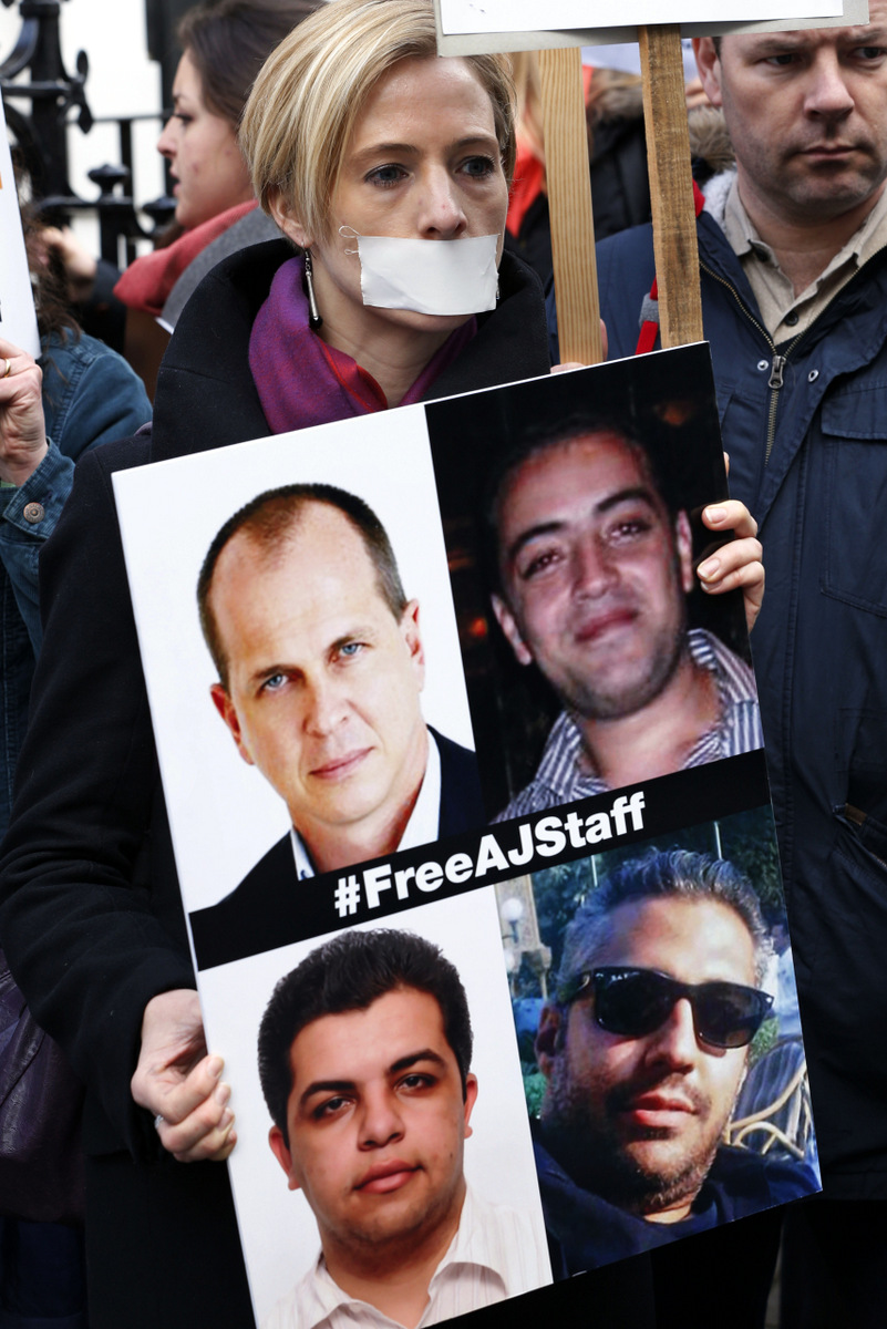 Journalists hold placards as they demonstrate
