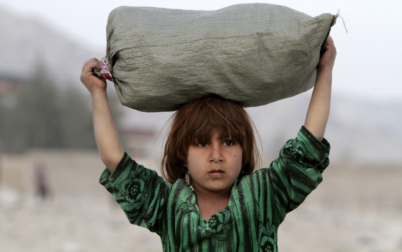 Shamila, 8, carries firewood in the Behsood district of Jalalabad, Afghanistan. Uncertainty over how many U.S. troops might remain in Afghanistan beyond this year has trickled down to American diplomats and aid workers whose efforts over the last decade to develop the still mostly primitive country faces a drawdown of its own because of security fears. (AP Photo/Rahmat Gul, File)