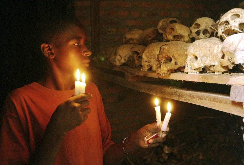 Apollan Odetta, a survivor from the 1994 Rwandan Genocide light candles at a mass grave in Nyamata, Rwanda. Two decades after the Rwandan genocide, France is finally opening what critics called its blind eye to justice over the killings.(AP Photo/Sayyid Azim, File)