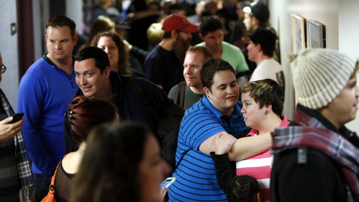 Couples wait to get marriage licenses at the Salt Lake County clerk's office in Salt Lake City, Utah. Utah state attorneys contend that the optimal environment for children to be raised is with a mother and father in its opening brief to a federal appeals court that is reviewing the state’s same-sex marriage ban. (AP Photo/Deseret News, Ravell Call, File)
