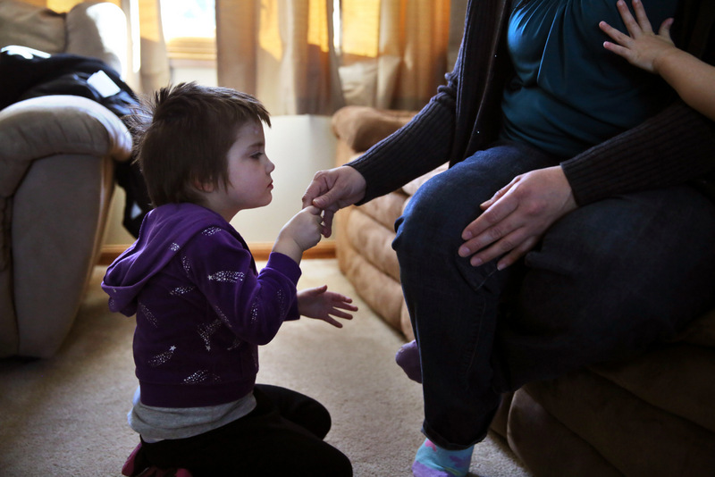 In this Feb. 7, 2014 photo, Elizabeth Burger, 4, holds her mother's hand at home in Colorado Springs, Colo. Elizabeth suffers from severe epilepsy and is receiving experimental treatment with a special strain of medical marijuana, which she takes orally as drops of oil.(AP Photo/Brennan Linsley)