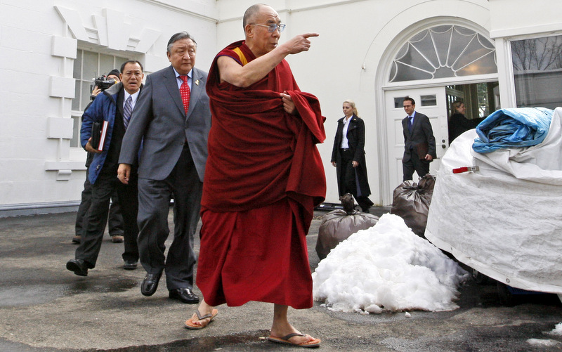 The Dalai Lama walks out of the White House in Washington, after meeting with President Barack Obama