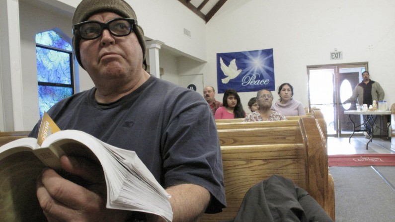 In this Thursday Jan. 30, 2014, photo, forklift driver William Felix, 56, attends a devotional at the Salvation Army in Los Banos, Calif.  Now unemployed, Felix said that he has been to a local cannery four times this winter asking for work with no luck. He doubts a call will come at all this year, given the state’s drought. “If we don’t get rain, we don’t get work,” Felix said. For now, he relies on free food from the Salvation Army as well as a spiritual boost. (AP Photo/Scott Smith)