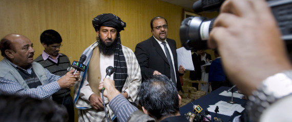 Kareem Khan, centre left, a Pakistani tribesman from North Wazirstan, is surrounded by media as his lawyer Mirza Shahzad Akbar, centre right, looks on, during a media conference in Islamabad, Pakistan, on Monday, Nov. 29, 2010. (AP Photo/Anjum Naveed)