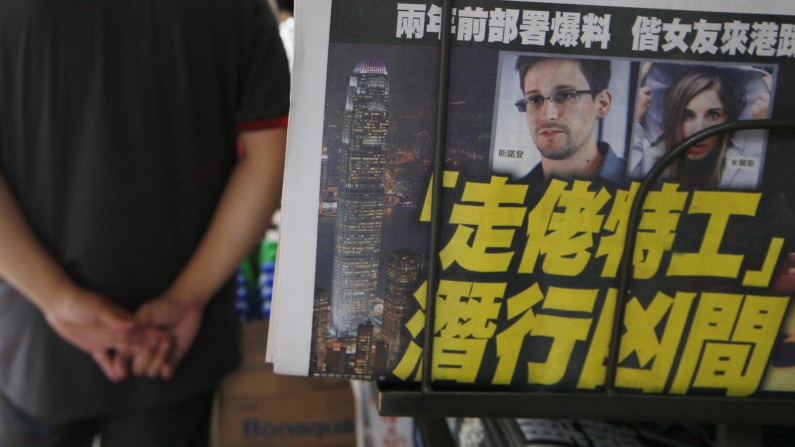 The picture of Edward Snowden, former CIA employee who leaked top-secret documents about sweeping U.S. surveillance programs, is displayed on the front page of a newspaper in Hong Kong Wednesday, June 12, 2013. The whereabouts of Snowden remained unknown Wednesday, two days after he checked out of a Hong Kong hotel. (AP Photo/Kin Cheung)