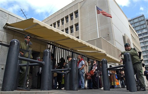 FILE - In this March 17, 2003 file photo, an Israeli border policemen guards the U.S. Embassy in Tel Aviv as other Israelis line up for U.S. visas. To ease the travel of its citizens, Israel is pressing to join 38 other countries in the U.S. Visa Waiver Program, a prestigious club of nations whose citizens dont need a preapproved visa to visit America. (AP Photo/Eitan Hess-Ashkenazi, File)