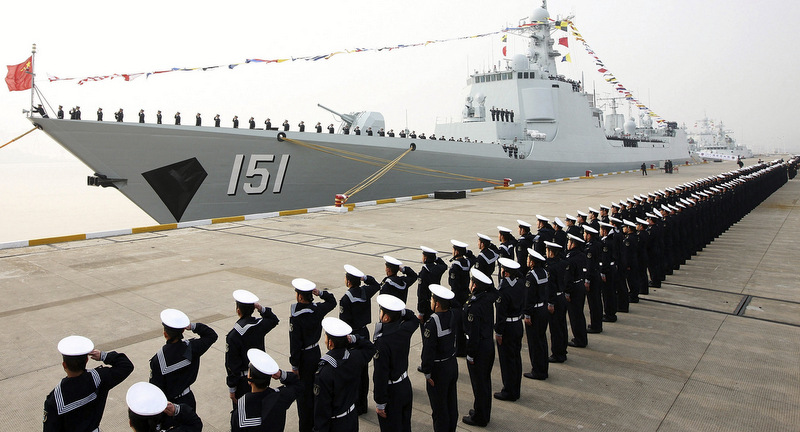 Chinese People's Liberation Army navy personnel salute in front of a new Type 052C guided missile destroyer Zhengzhou during its commission ceremony in Zhoushan, in eastern China's Zhejiang province. (AP Photo) 