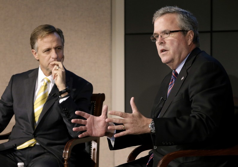 FILE - This Jan. 14, 2013 file photo shows former Florida Gov. Jeb Bush, right, and Tennessee Gov. Bill Haslam talking about education reform during a forum in Nashville, Tenn. More than five years after governors from both major parties began a mostly quiet effort to set new standards in American schools, the so-called Common Core initiative has morphed into a political tempest that fuels division among Republicans. Bush hails Common Core as a way to improve student performance and, over the long term, competitiveness of American workers. (AP Photo/Mark Humphrey, File)