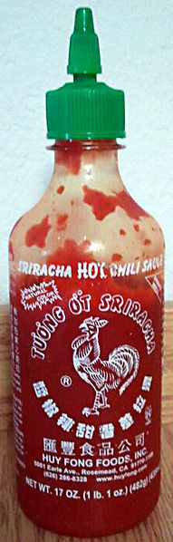A bottle of Sriracha sauce.