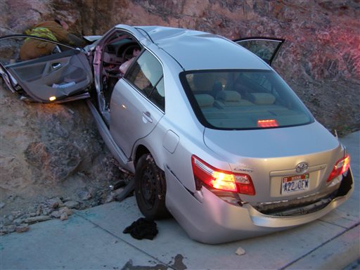 In this Nov. 5, 2010 file photo released by the Utah Highway Patrol, a Toyota Camry is shown after it crashed as it exited Interstate 80 in Wendover, Utah. Police suspect problems with the Camry's accelerator or floor mat caused the crash that left two people dead and two others injured. The Wall Street Journal is reporting Wednesday March 19, 2014 the U.S. Justice Department may reach a $ 1 billion settlement with Toyota Motor Corp., ending a four-year criminal investigation into the Japanese automaker's disclosure of safety problems. (AP Photo/Utah Highway Patrol, File)