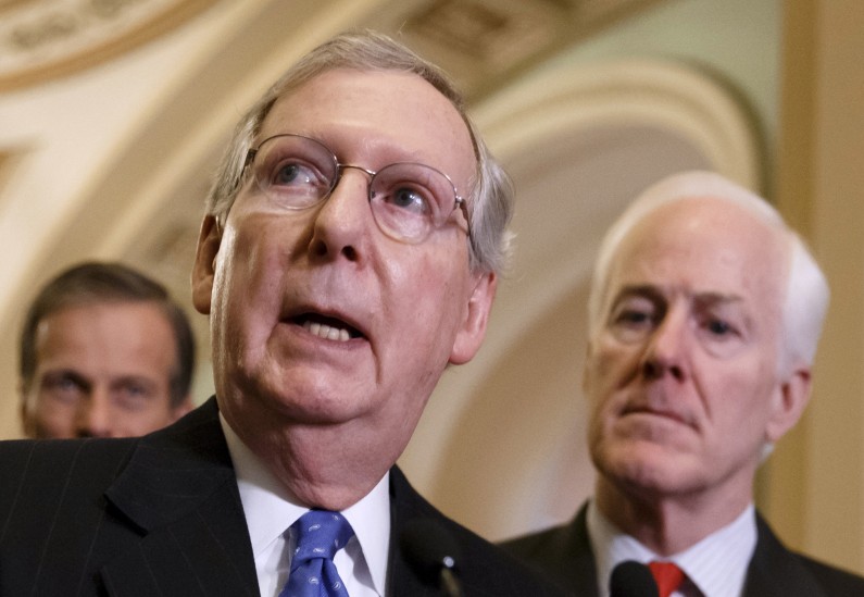 FILE - This March 25, 2014 file photo shows Senate Minority Leader Mitch McConnell of Ky., center, speaking to reporters on Capitol Hill in Washington. Republicans in the 2014 midterm elections cant seem to reach an official party line on that the old Washington practice of writing the federal budget to benefit the folks back home. Sure, top Republicans like McConnell _ now Senate minority leader _ and former Senate Appropriations Chairman Thad Cochran of Mississippi begrudgingly banned so-called earmarks more than three years ago. They were reacting both to the tea partys rise and a push from conservative House Republicans like Georgia Rep. Jack Kingston, now a House Appropriations subcommittee chairman. McConnell is accompanied by Sen. John Thune, R-S.D., left, and Senate Minority Whip John Cornyn of Texas. (AP Photo/J. Scott Applewhite, File)