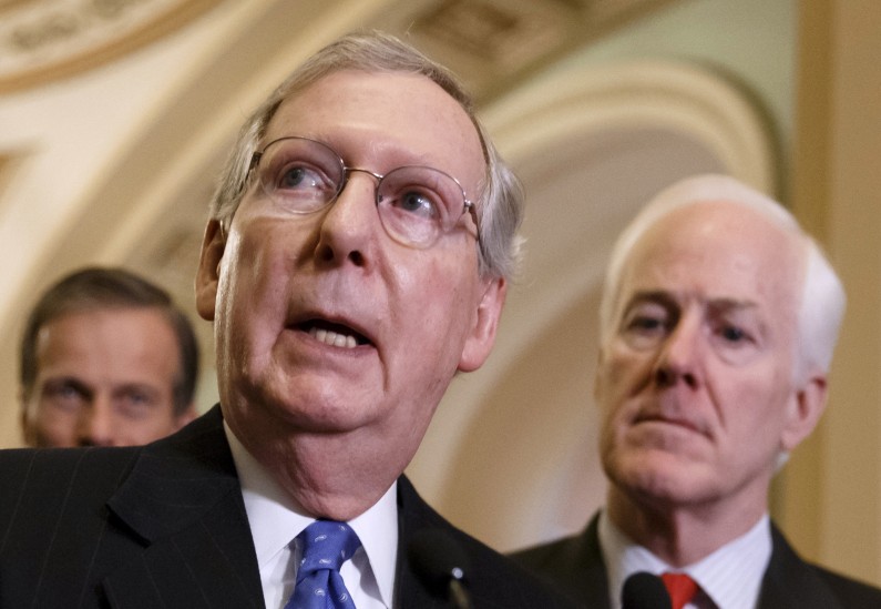 FILE - This March 25, 2014 file photo shows Senate Minority Leader Mitch McConnell of Ky., center, speaking to reporters on Capitol Hill in Washington. Republicans in the 2014 midterm elections cant seem to reach an official party line on that the old Washington practice of writing the federal budget to benefit the folks back home. Sure, top Republicans like McConnell _ now Senate minority leader _ and former Senate Appropriations Chairman Thad Cochran of Mississippi begrudgingly banned so-called earmarks more than three years ago. They were reacting both to the tea partys rise and a push from conservative House Republicans like Georgia Rep. Jack Kingston, now a House Appropriations subcommittee chairman. McConnell is accompanied by Sen. John Thune, R-S.D., left,  and Senate Minority Whip John Cornyn of Texas.  (AP Photo/J. Scott Applewhite, File)