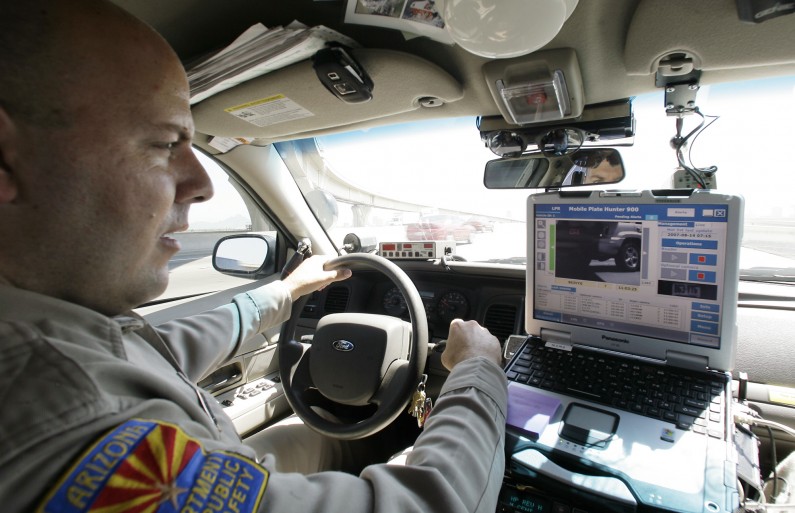 ** HOLD FOR BENNY SNYDER ** ADVANCE FOR SUNDAY SEPT. 9 ** Arizona Department of Public Safety officer David Callister adjusts his infrared camera mounted on the front bumper of his police cruiser Tuesday, Aug. 14, 2007, in Phoenix.  (AP Photo/Ross D. Franklin)
