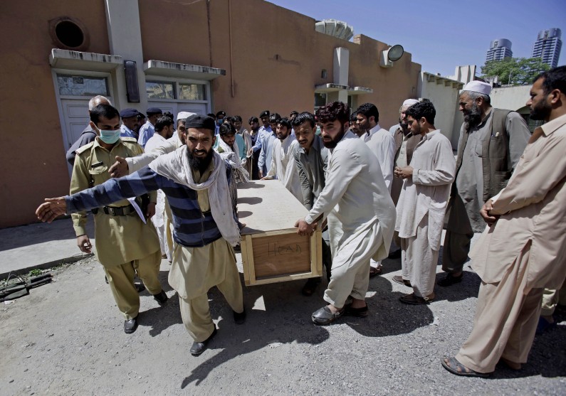 Pakistanis carry the casket of their relative, a victim of a bomb blast, after receiving him from a morgue at a local hospital in Islamabad, Pakistan, Wednesday, April 9, 2014. A bomb ripped through a fruit and vegetable market on the outskirts of the Pakistani capital of Islamabad on Wednesday morning, killing and wounding dozens, officials said. (AP Photo/Anjum Naveed)