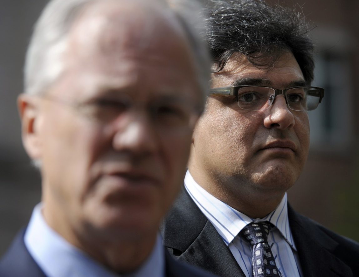 Former CIA officer John Kiriakou, right, listens as his attorney Robert Trout speaks with reporters outside of the U.S. District Court in Alexandria, Va., Oct. 23, 2012, after Kiriakou pleading guilty, in a plea deal, to leaking the names of covert operatives to journalists. (AP/Cliff Owen)