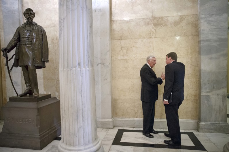Sen. Mark Warner, D-Va., right, and House Minority Whip Steny Hoyer of Md. confer during a chance encounter on Capitol Hill in Washington, Wednesday, Feb. 26, 2014.  (AP Photo/J. Scott Applewhite)