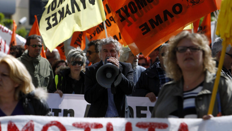 A protester chants anti-austerity slogans through a loud hailer during a rally in the northern Greek port city of Thessaloniki, Greece, Wednesday, April 9, 2014.