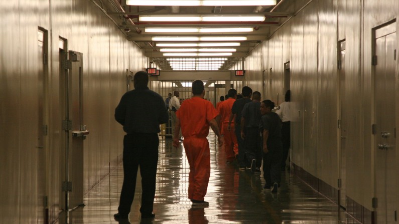 ** TO GO WITH CENTRO DE DETENCION ** This April 13, 2009 photo shows a detainee at Immigration and Customs Enforcement's Stewart Detention Center in Lumpkin, Ga., leaving the cafeteria after lunch to go back to their living units. The all-male detention center with a capacity of 1,924 detainees is operated on contract by Nashville-based Corrections Corporation of America, the country's largest private prison firm. (AP Photo/Kate Brumback)