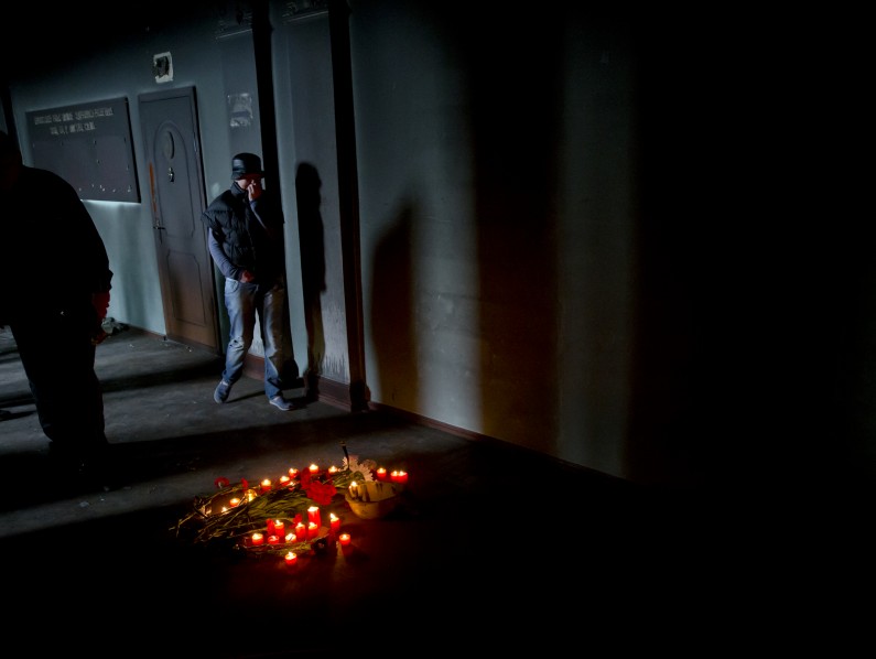 People walk inside the burnt trade union building, in Odessa, Ukraine, Sunday, May 4, 2014, where people died in in a fire that tore through the building. More than 40 people died in riots two days earlier, some from gunshot wounds, but most in a horrific fire that tore through a trade union building. (AP Photo/Vadim Ghirda)