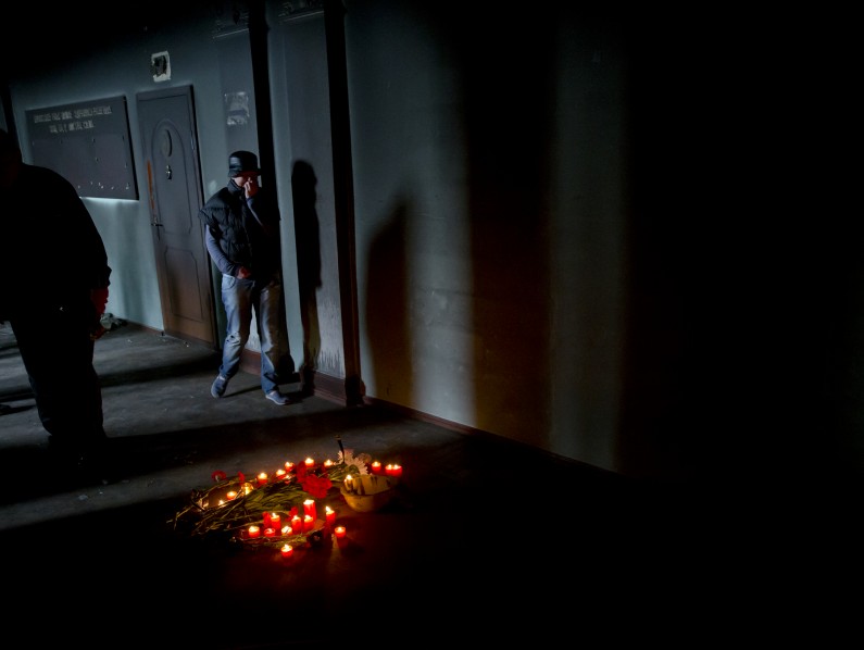 People walk inside the burnt trade union building, in Odessa, Ukraine, Sunday, May 4, 2014, where people died in in a fire that tore through the building. More than 40 people died in riots two days earlier, some from gunshot wounds, but most in a horrific fire that tore through a trade union building. (AP Photo/Vadim Ghirda)