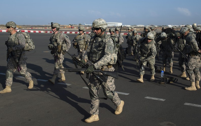 In this photo taken Wednesday, Dec. 18, 2013 and released by the U.S. Air Force, U.S. Army soldiers of the East Africa Response Force (EARF), a Djibouti-based joint team assigned to Combined Joint Task Force-Horn of Africa, prepare to load onto a U.S. Air Force C-130 Hercules at Camp Lemonnier, Djibouti, to support with an ordered departure of personnel from Juba, South Sudan. Gunfire hit three U.S. military CV-22 Osprey aircraft Saturday, Dec. 21, 2013 trying to evacuate American citizens in Bor, the capital of the remote region of Jonglei state in South Sudan, that on Saturday became a battle ground between South Sudan's military and renegade troops, officials said, with four U.S. service members wounded in the attack. (AP Photo/U.S. Air Force, Tech. Sgt. Micah Theurich)