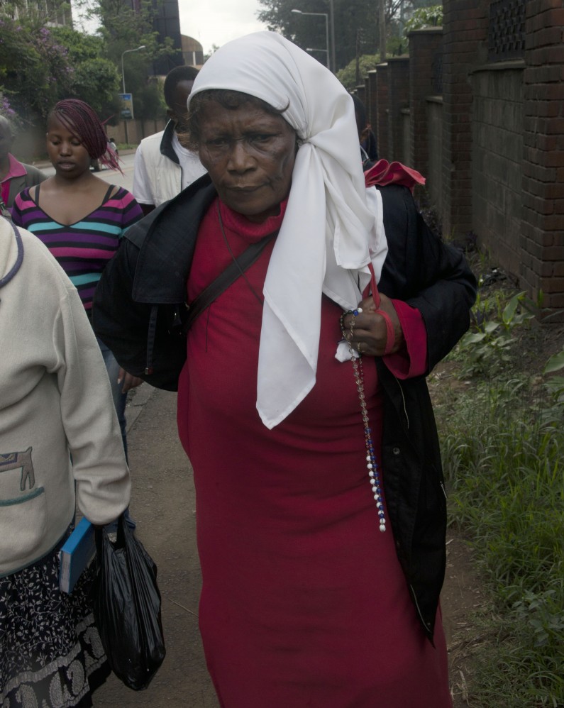 A faithful Christian holding a rosary as she joins hundreds of Catholic Christians marching through the streets of Nairobi, Kenya, Friday, April 18, 2014, during the Holy Week. Easter marks the end of Lent, a forty-day period of fasting, prayer, and penance. The last week of the Lent is called Holy Week, and it contains Good Friday, commemorating the crucifixion and death of Jesus. (AP Photo/Sayyid Azim)