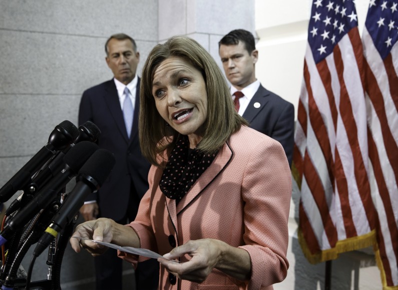 Rep. Lynn Jenkins, R-Kansas, accompanied by House Speaker John Boehner of Ohio, left, and Rep. Todd Young, R-Ind, attacks the excuse given by the Internal Revenue Service (IRS) that it has lost more emails connected to a tea party investigation, Wednesday, June 18, 2014, during a news conference on Capitol Hill in Washington.  (AP Photo/J. Scott Applewhite)