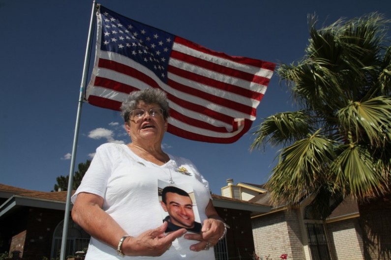 Lillian "Bonnie" D'Amico, poses for a photograph while holding a photo of her son Nicholas D'Amico in El Paso, Texas, Wednesday, June 11, 2014. Her son killed himself while waiting for a an appointment with a psychiatrist. Some Veterans Affairs facilities in Texas have among the longest wait-times in the nation for those trying to see a doctor for the first time, according to federal data released Monday. (AP Photo/Juan Carlos Llorca)