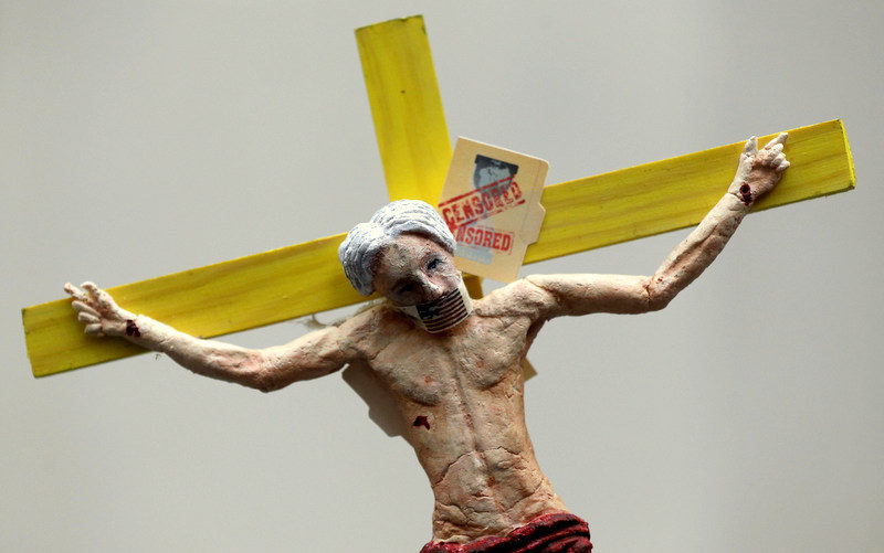 A figure depicts Julian Assange on a cross on top of a supporter of WikiLeaks founder Julian Assange during a vigil outside the Ecuadorian Embassy in London.