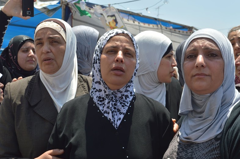 Mohammed Abu Khdeir's mother (middle) mourns the loss of her son at his funeral on Friday. (Photo by Sheren Khalel for Mint Press)
