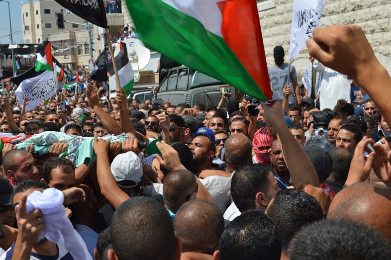 Body of 17-year-old Mohammed Abu Khdeir is carried into mosque before being wrapped and placed in casket. (Photo by Matthew Vickery for Mint Press)