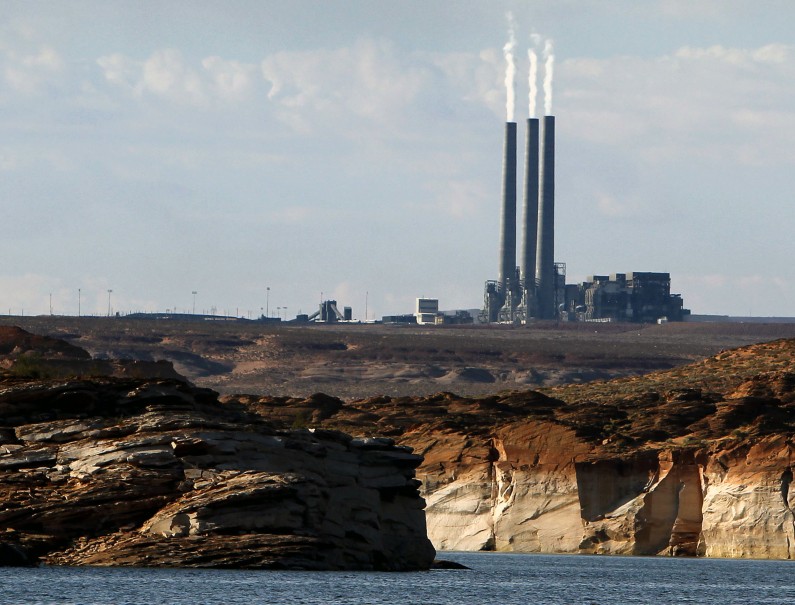 This Sept. 4, 2011, file photo shows the main plant facility at the Navajo Generating Station, as seen from Lake Powell in Page, Ariz. The federal government has come up with a final version of a rule meant to cut haze-causing emissions from the largest coal-fired power plant in the West. The U.S. Environmental Protection Agency's decision Monday, July 28, 2014, reflects a compromise by tribal and federal officials, environmental groups and the owners of the Navajo Generating Station, which is on track to cease operations in 2044. (AP Photo/Ross D. Franklin, File)