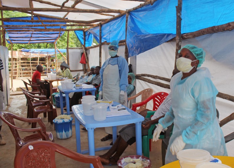 In this photo taken on Sunday, July 27, 2014,  Medical personnel inside a clinic taking care of Ebola patients in the Kenema District on the outskirts of Kenema, Sierra Leone.  Liberia President Ellen Johnson Sirleaf has closed some border crossings and ordered strict quarantines of communities affected by the Ebola outbreak. The announcement late Sunday came a day after Sirleaf formed a new taskforce charged with containing the disease, which has killed 129 people in the country and more than 670 across the region.(AP Photo/ Youssouf Bah)
