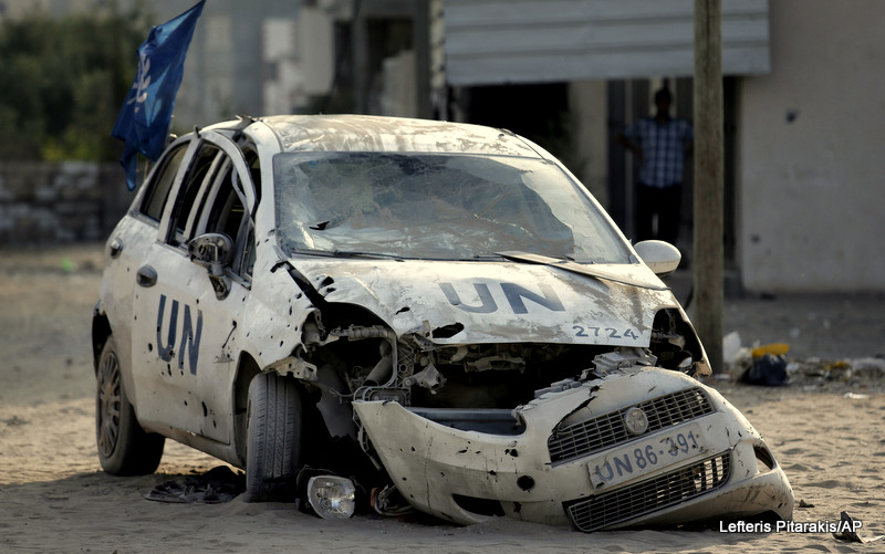 A United Nations aid agency car lies destroyed by shrapnel from an Israeli strike in the Jebaliya refugee camp, northern Gaza Strip, Tuesday, July 29, 2014.