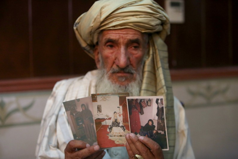 Hajji Sharfddin 67,holds photographs of relatives, who went missing in Nov. 2012, during U.S. military operations in Gardez province, east of Kabul, Afghanistan, durung a news conference in Kabul Monday, Aug. 11, 2014. The U.S. failed to properly investigate civilian killings, including possible war crimes, which occurred during its military operations in Afghanistan, the international rights group Amnesty International said Monday. NATO said it investigates all credible reports of civilian casualties, without responding to the group's specific claims.(AP Photo/Rahmat Gul)