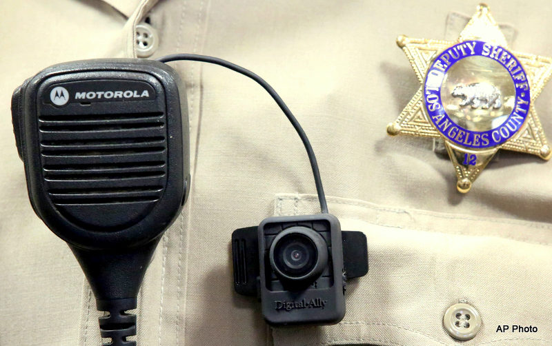 A Police body camera is displayed at a news conference